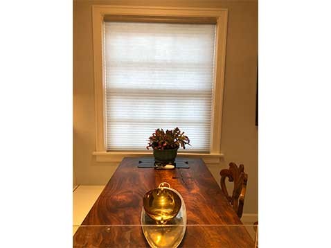 Long wooden table with a centerpiece 